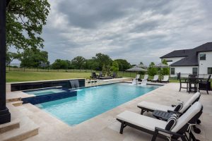 swimming pool with sun loungers
