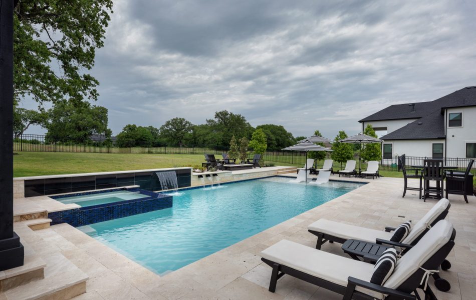 swimming pool with sun loungers